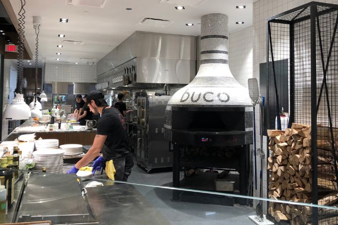 Marra forni customer buco using the commercial wood fired pizza oven in their restaurant image
